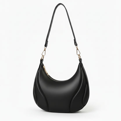 Black handbag with a strap on a white background