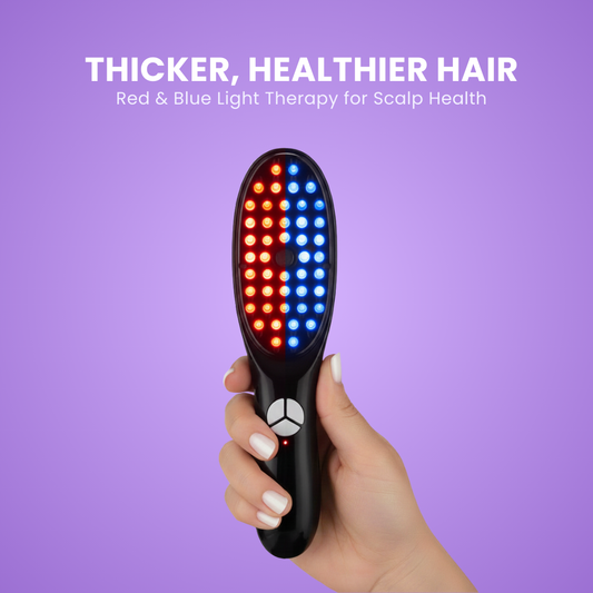 Black LED hairbrush with red and blue lights held by a hand against a purple background